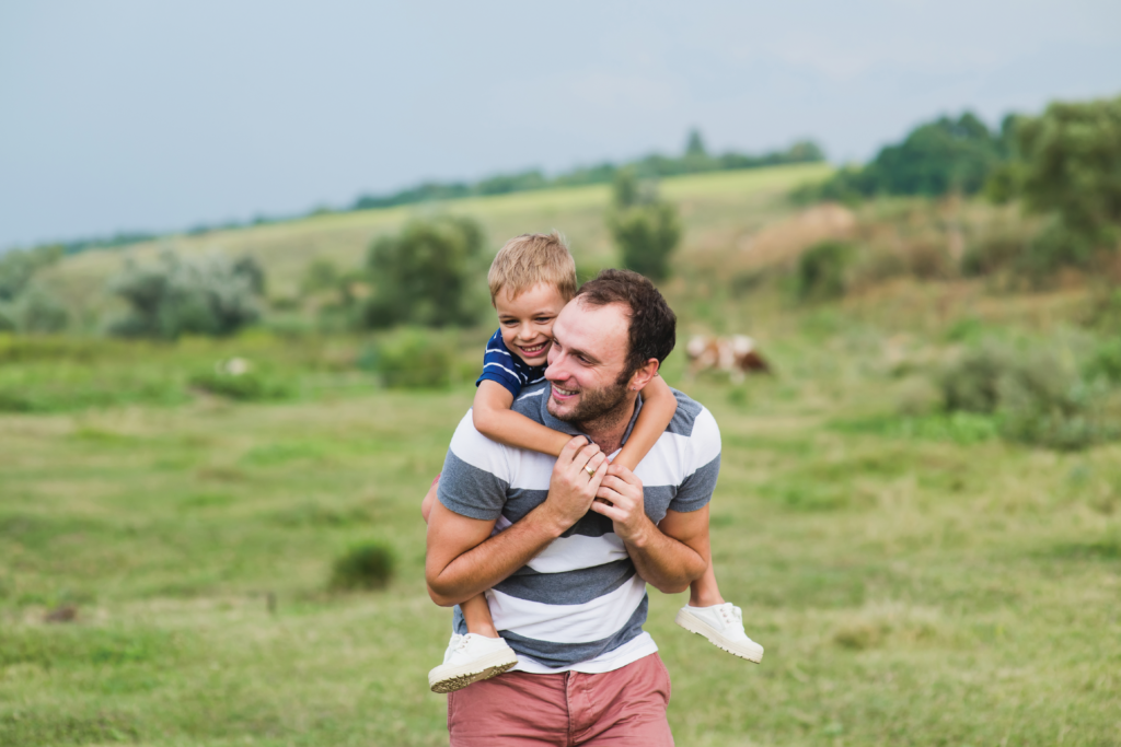 man carrying boy on his shoulders