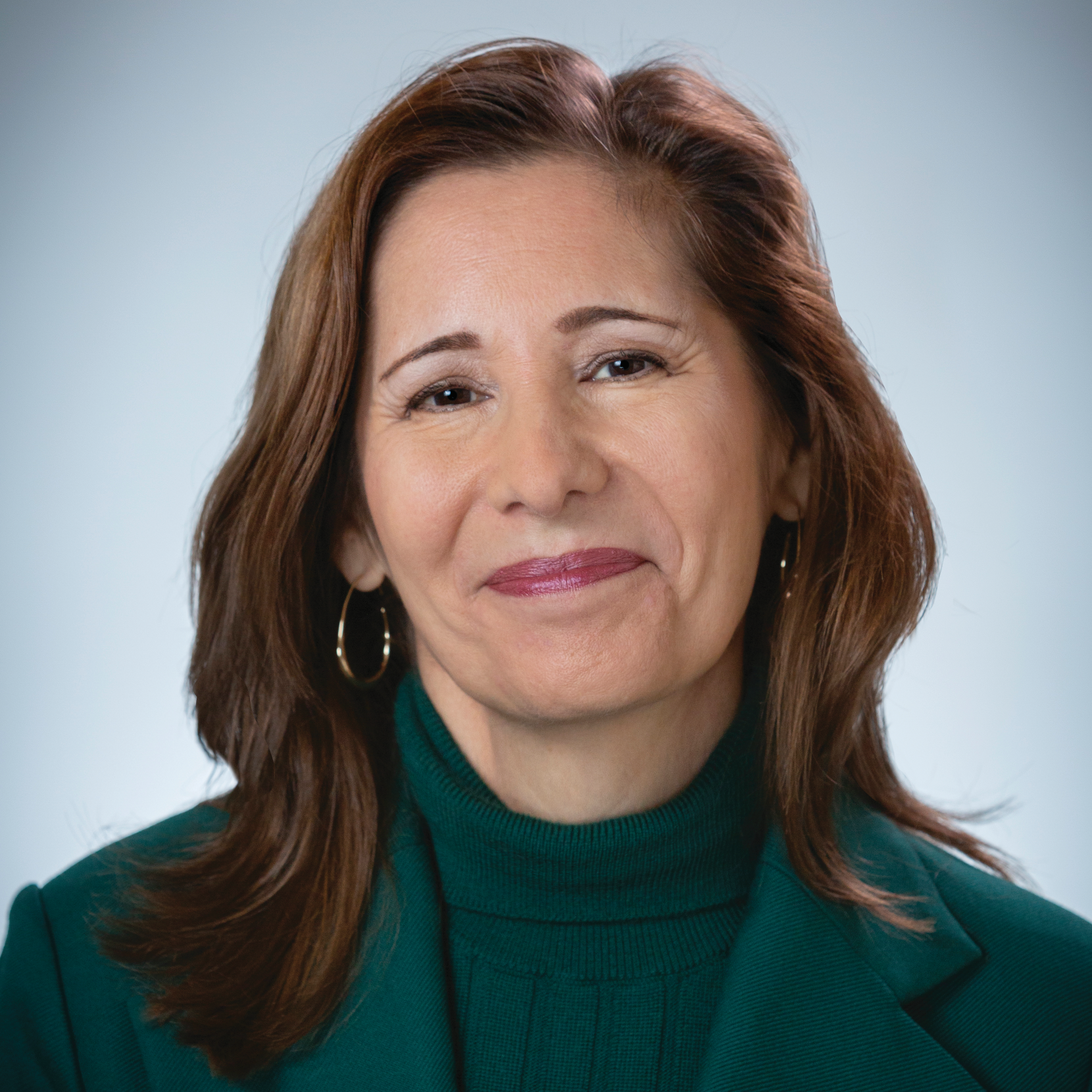Woman in green blazer smiling